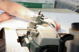 Inmate sewing textiles with sewing machine