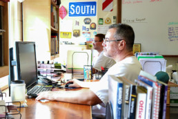 Inmates working on computers to design signs at the sign shop in Gunnison Utah