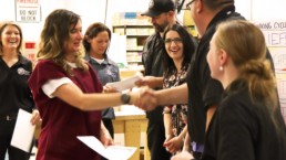 Makin it work graduate receiving her certification and shaking hands with UCI staff