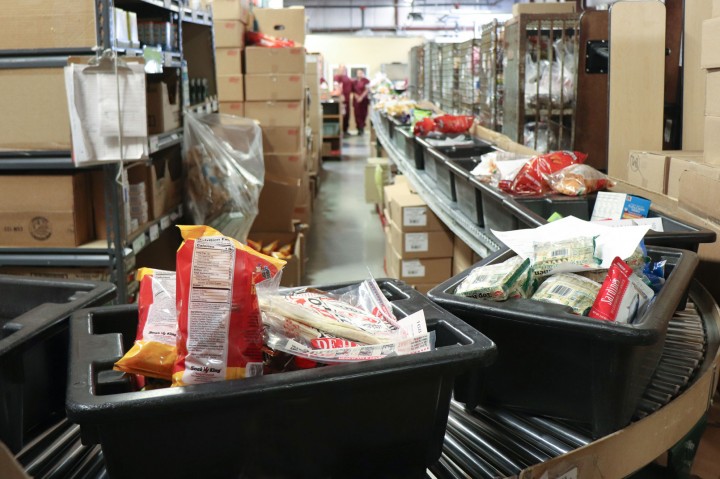 Bins with food on conveyor belt