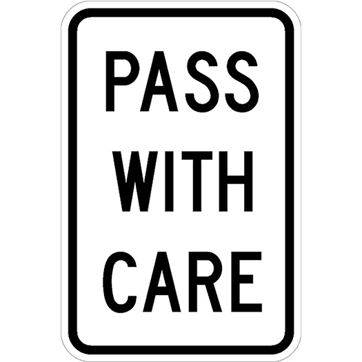 PASS WITH CARE road sign with black text on white background.
