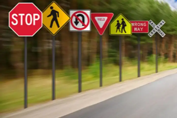 Traffic signs lining road