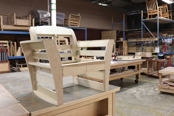 White wooden chair frame getting ready for upholstery in furniture shop