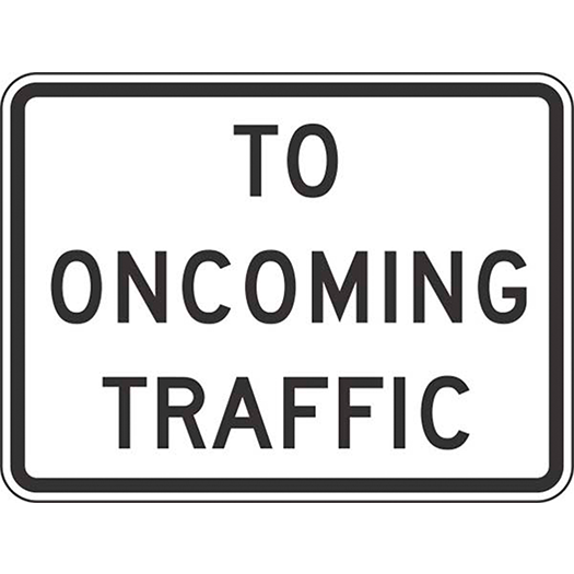 A "To Oncoming Traffic" road sign in bold black on a white background.